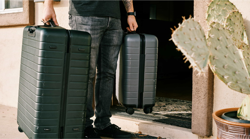 Man holding two suitcases. 